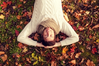 person laying on grass and leaves