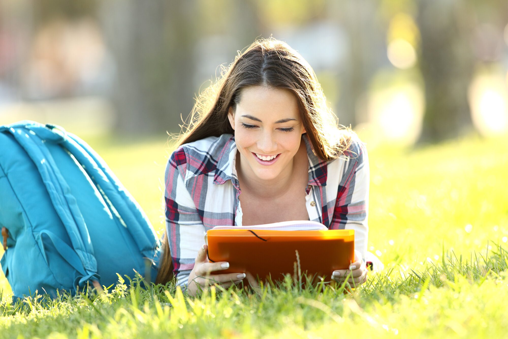 student reading in grass