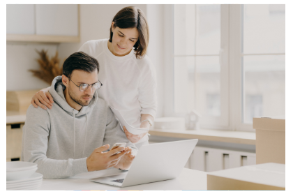 Retired couple with financial adivsor sitting at a desking signing paperwork.