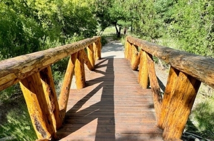 Retired couple sitting on a park bench after a bike ride.