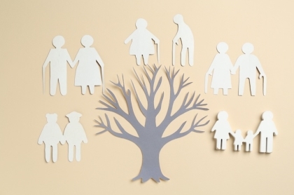 Family sitting together on a dock watching child splash in the water. 